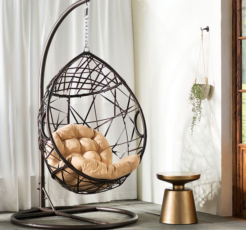 Egg shaped swinging chair in room
