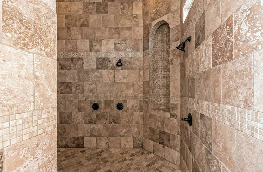 Extra large travertine shower with arched alcove and high ceiling