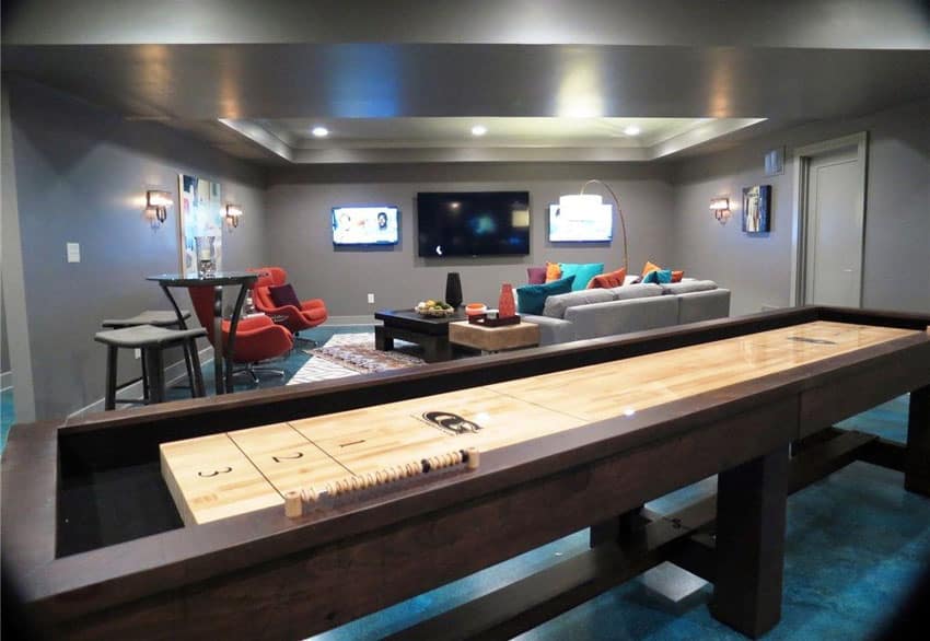 Gray basement with contemporary furniture and shuffleboard table