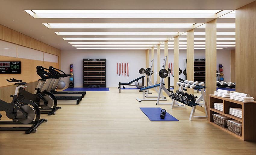 Luxury basement home gym with exercise equipment and weight bench