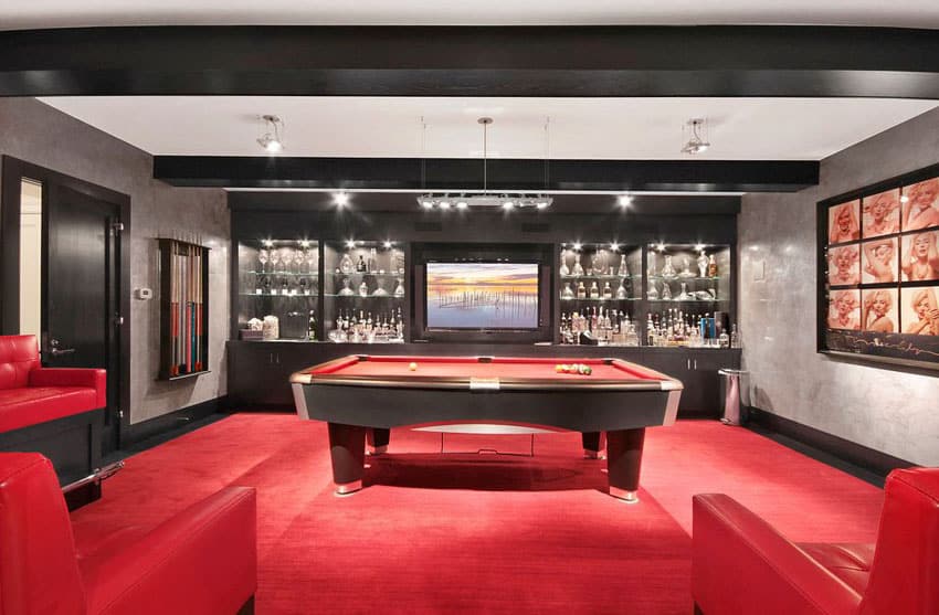 Basement man cave with red billiards table and black bar