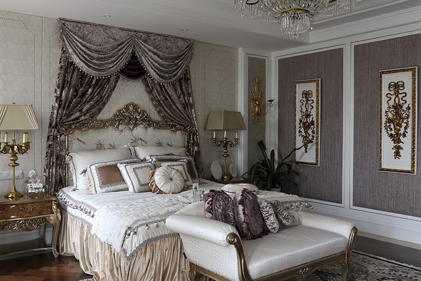 Luxury french provincial bedroom with gold gilded furniture and purple wall panels and decor