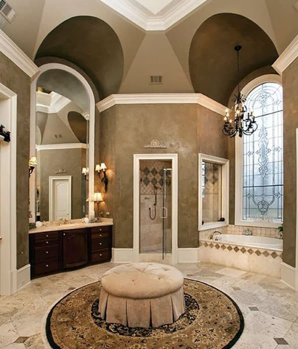 Luxury master bathroom with travertine tile shower and high ceilings