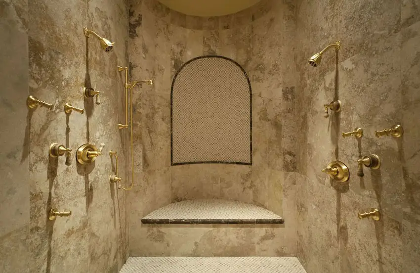 Shower with stone wall and gold fixtures