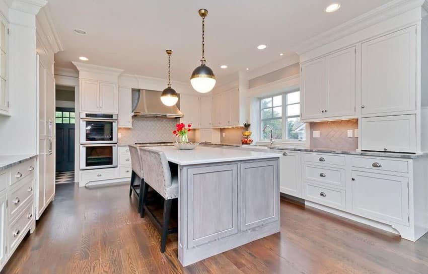 Luxury white cabinet kitchen with white counter island and two bench breakfast bar dining area