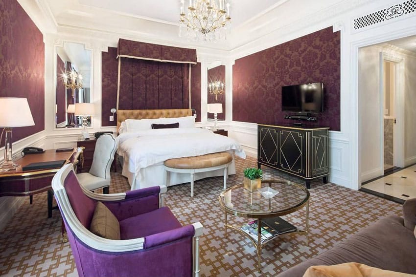 Master bedroom with purple textured walls decor and gold chandelier