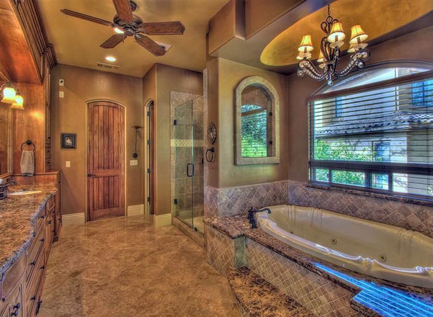 Mediterranean bathroom with chandelier and rustic design finishes