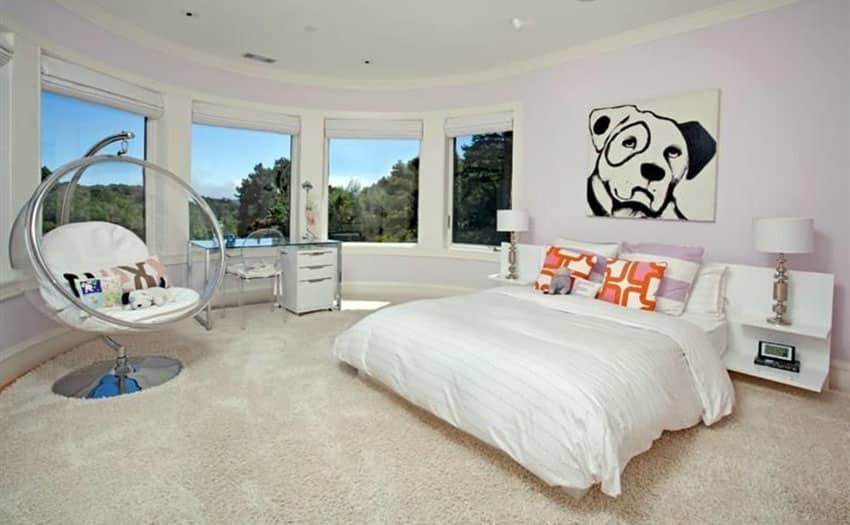 Modern master bedroom with pink painted walls and floor mount swing chair