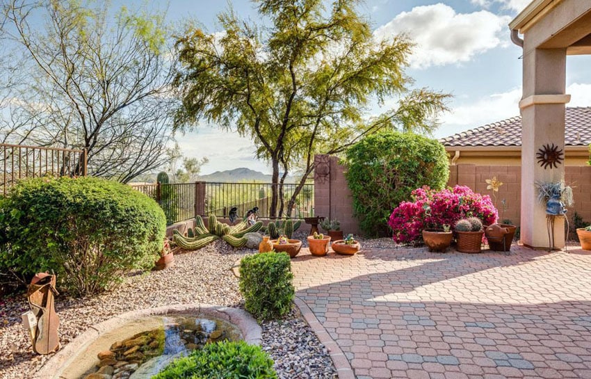 Paver patio with landscaping and water feature pond