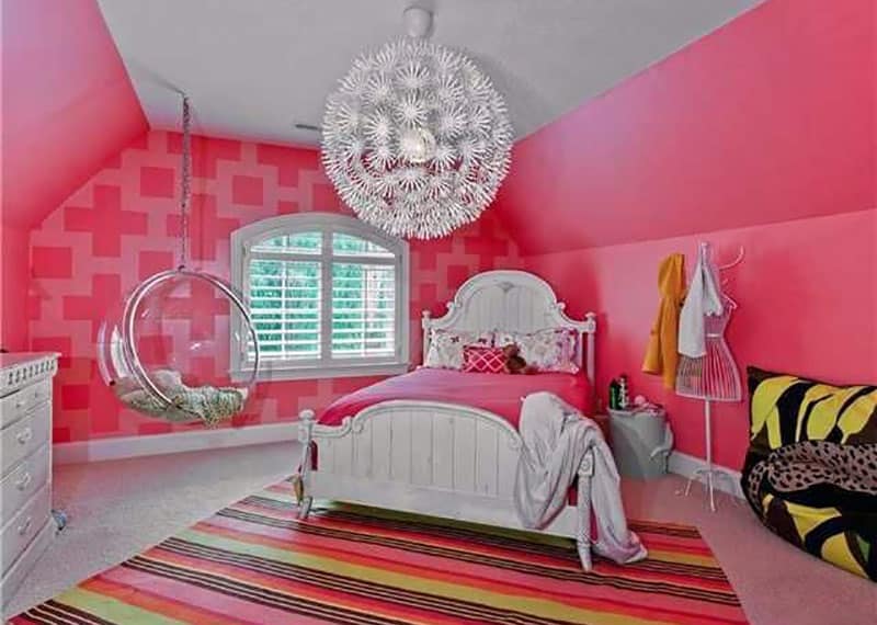 Pink girls bedroom with round swinging chair with clear sides