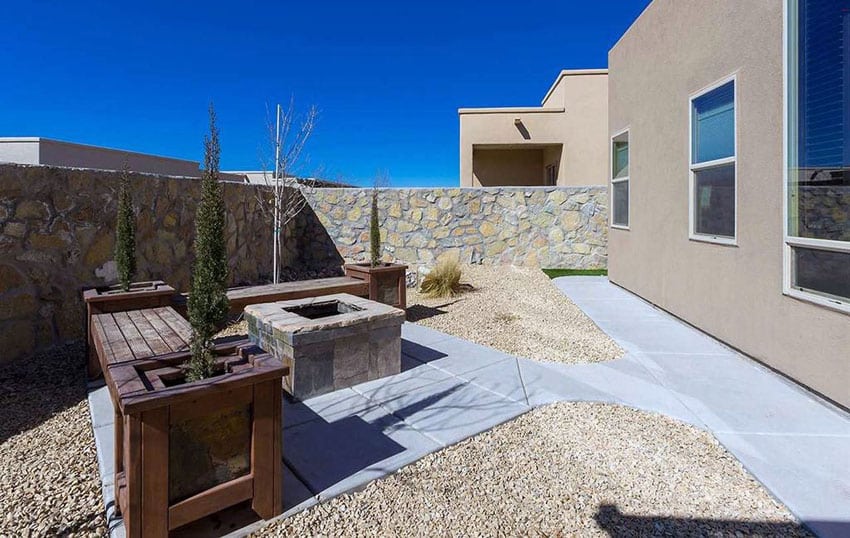 Poured concrete and gravel rocks with wood benches 