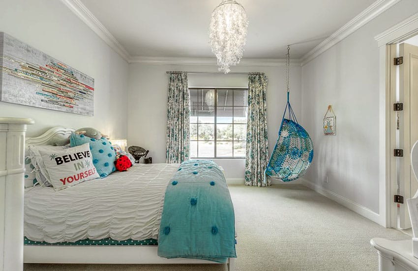 pretty girls bedroom with aqua color hanging chair and feather chandelier