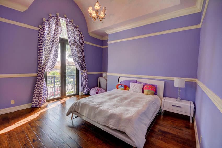 Purple girls bedroom with wood floors and solitude paint with cream molding