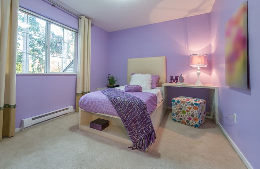 Purple feminine bedroom with cream color curtains, bed and end table