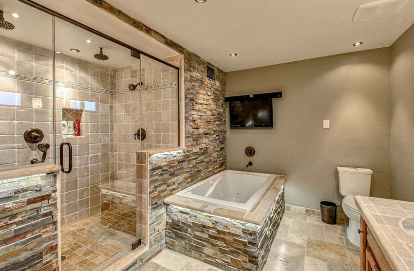 Rustic expansive bathroom with travertine and stacked stone walled shower 