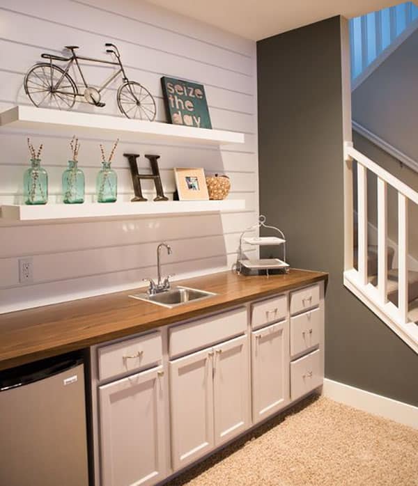 Small basement kitchen with shiplap wood siding and open shelving