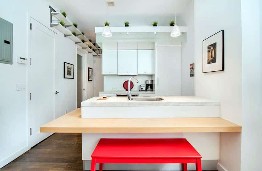 Small white contemporary kitchen with marble peninsula and red bench seating