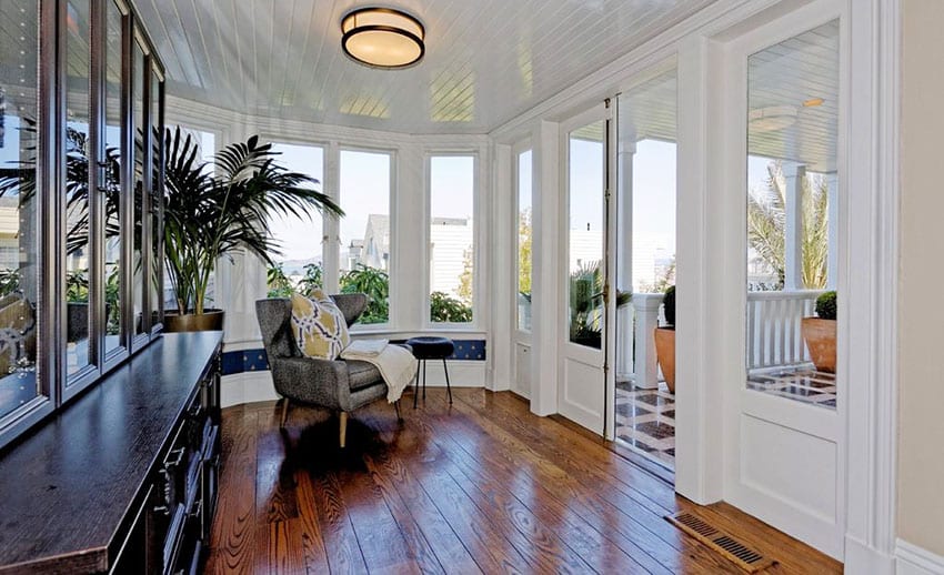 Sunroom with wooden floors, flush lighting and black cabinets