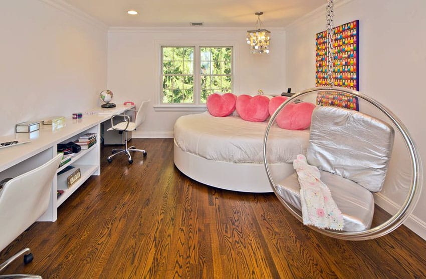 Teen girls bedroom with bubble hanging chair with silver cushions and heart shaped bed