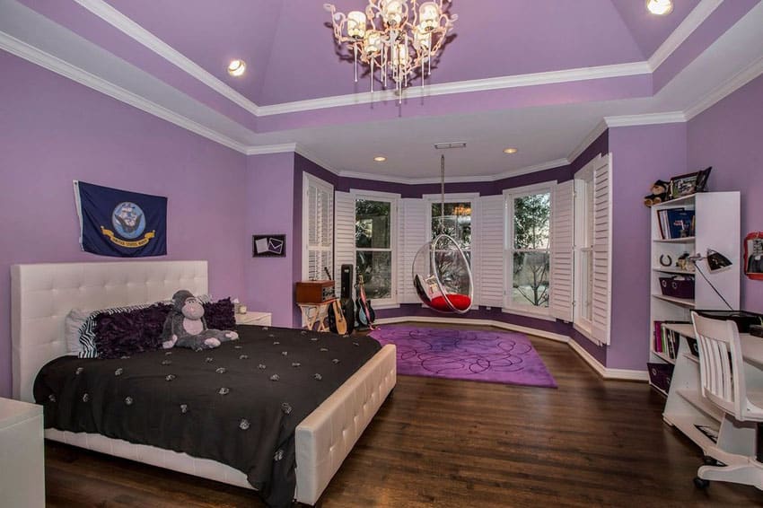 Teens bedroom in purple with swinging bench and wood floors
