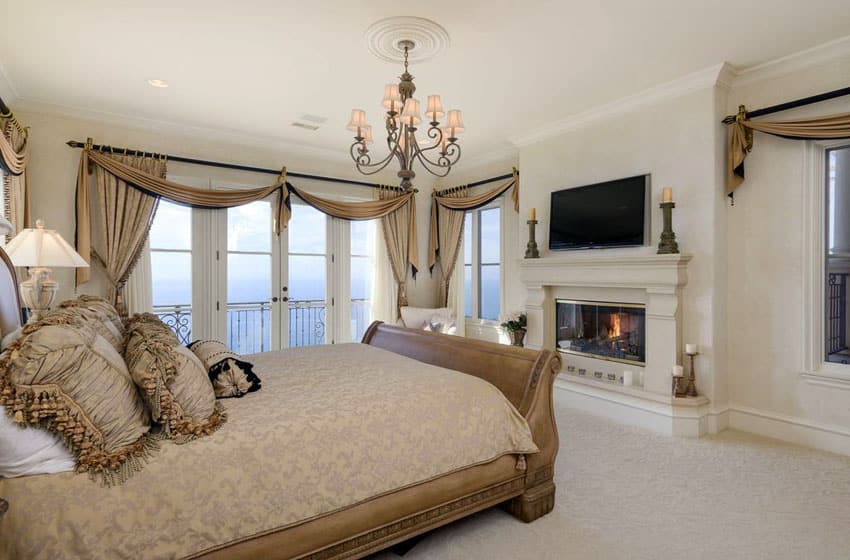 Traditional created bedroom with elegant fireplace ocean views and balcony