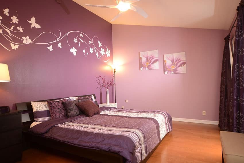 Two tone purple bedroom with wall decals and curtains and bed comforter