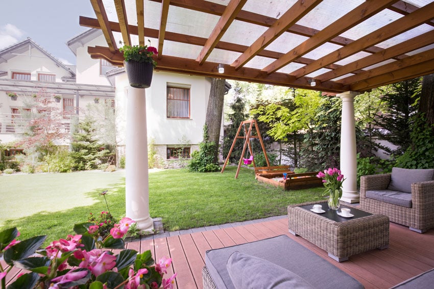 Pergola with polucarbonate roofing and white columns