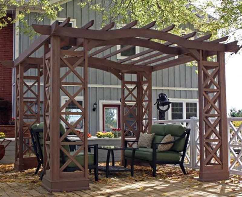 Cedar pergola with bracket shaped support and x fretwork