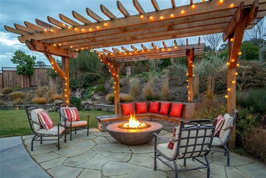 Cedar pergola with hanging lights over bowl fire pit