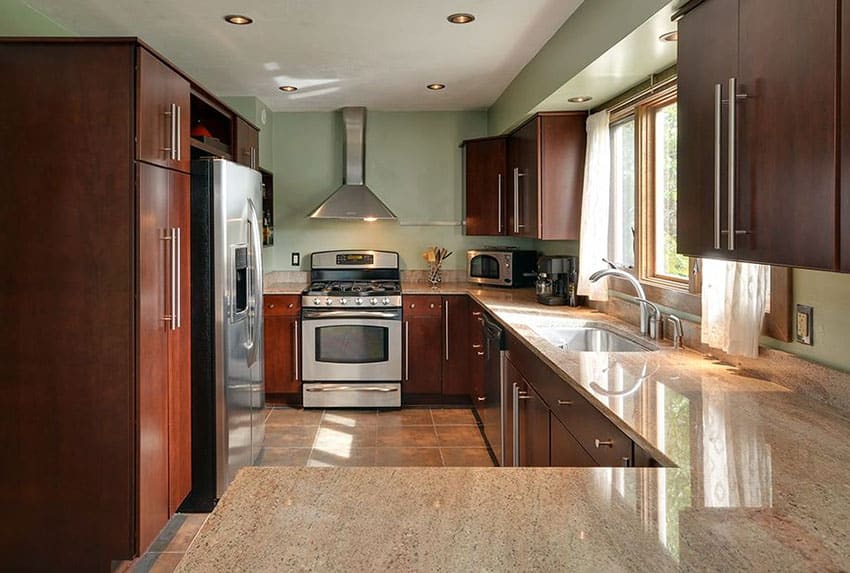 Kitchen with windows with curtains, cabinets and countertop