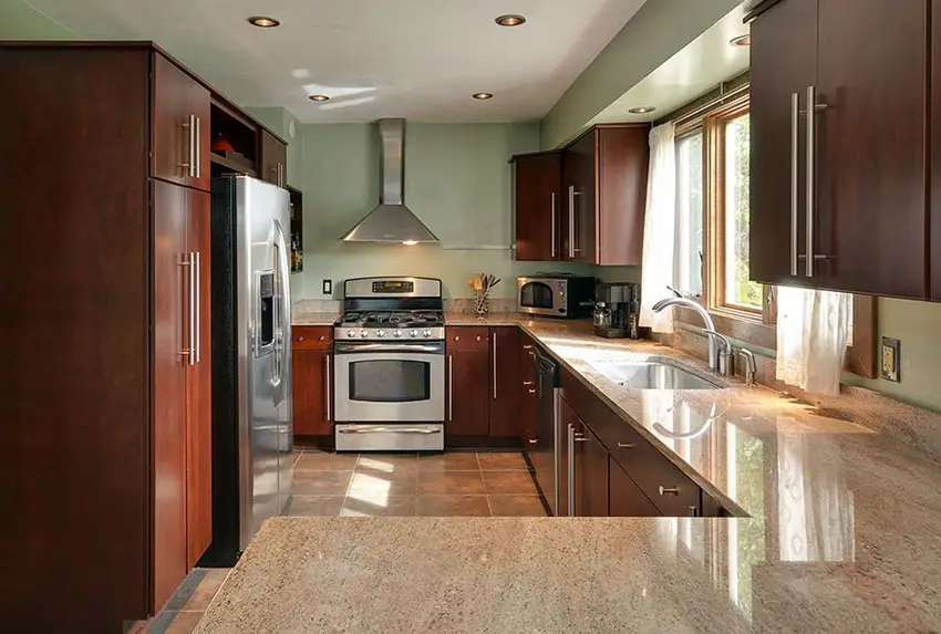 Kitchen with green wall paint and ivory fantasy granite counters 