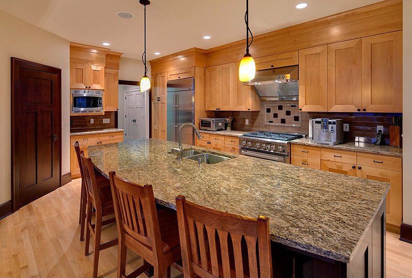 Kitchen with custom cabinets, pendant lighting and wood door