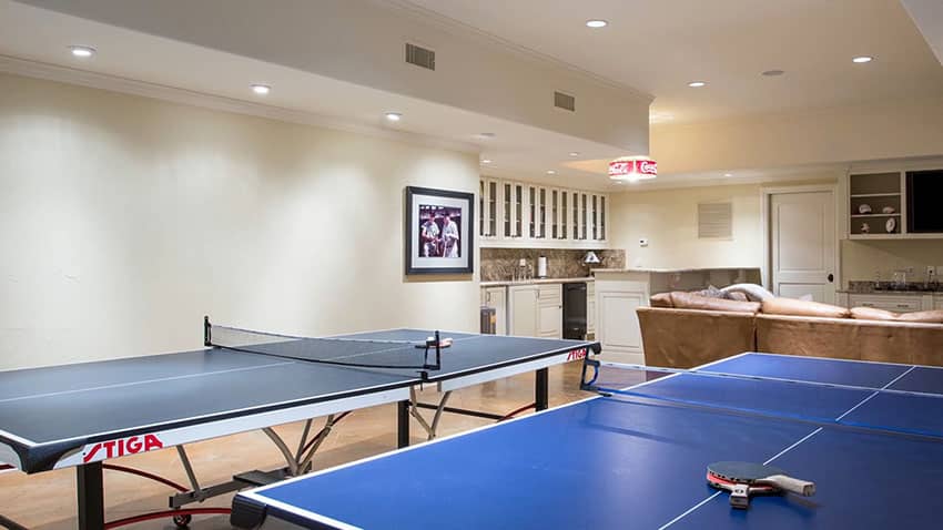Finished basement game room with pool tables and wet bar