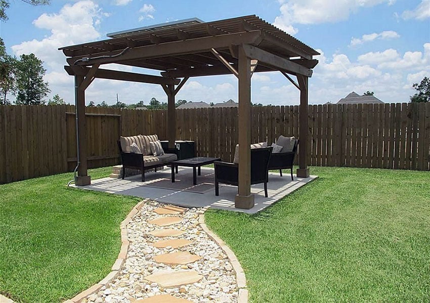 flagstone and river rock path leading to pergola with outdoor furniture