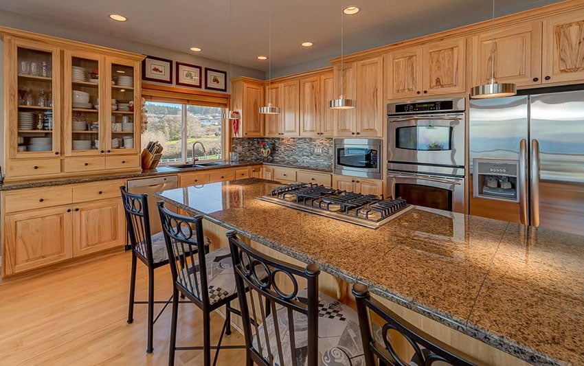 Kitchen with cabinets without any finish and countertop made of granite