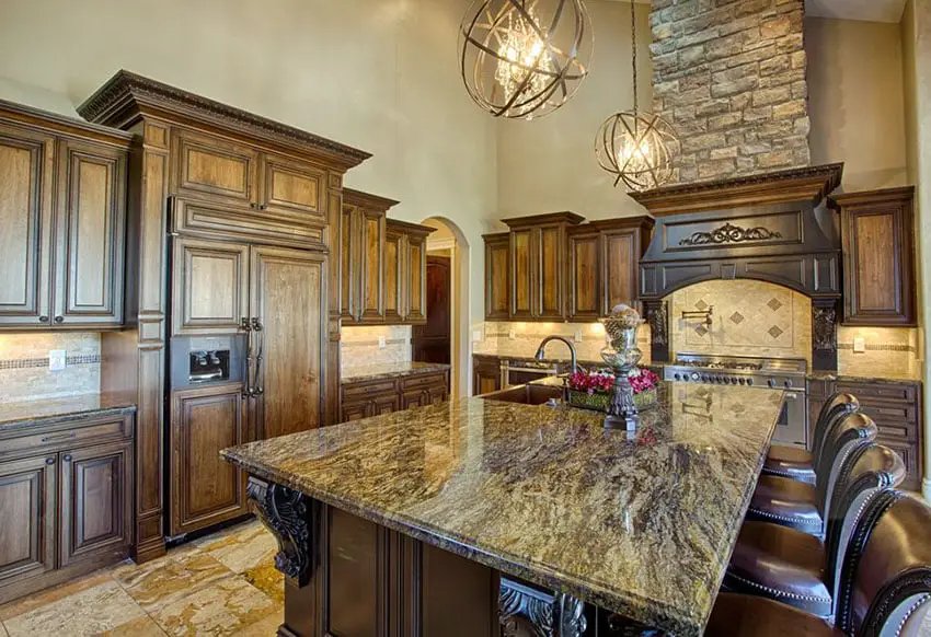 Kitchen with modern globe chandeliers over a brown granite island