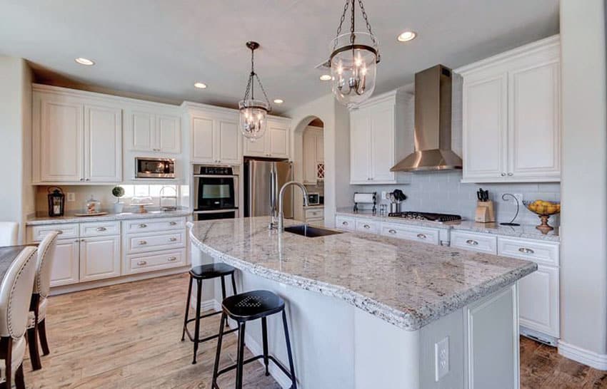 Kitchen with moon white granite counters and white cabinets