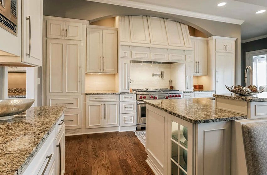Kitchen with white cabinets and bianco antico granite