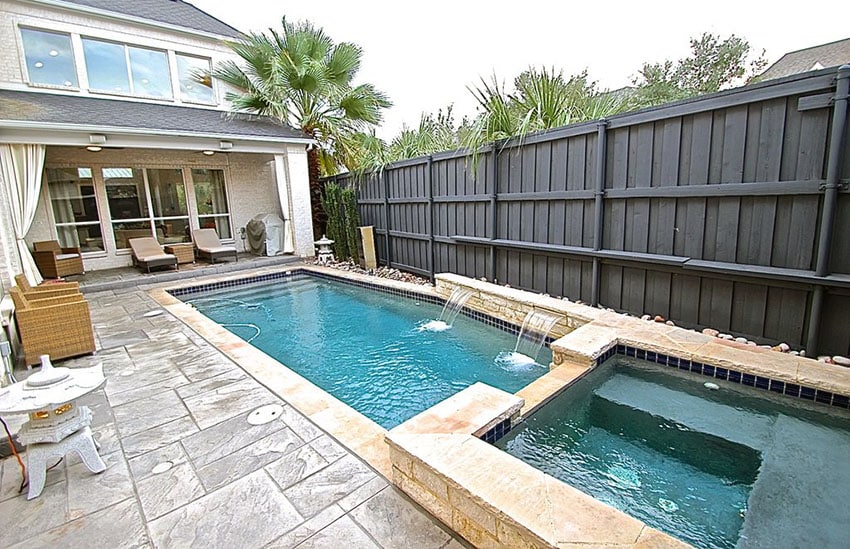 Large black painted wood and metal privacy fence around pool
