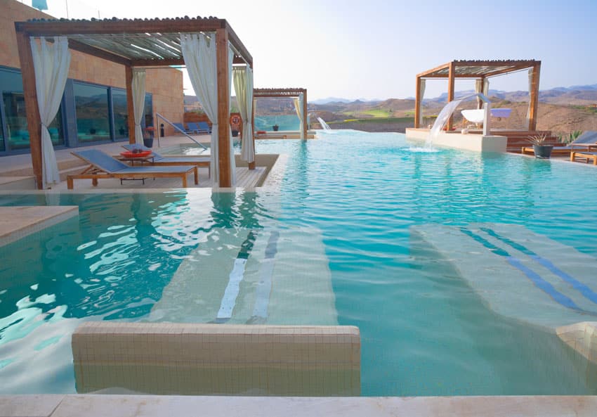 Lounge area with pergola in an infinity pool