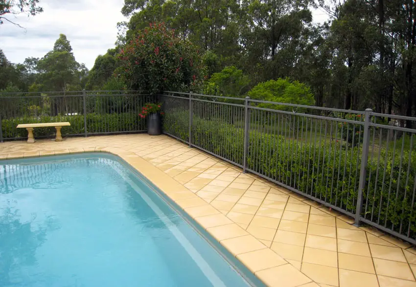 Partial view of a pool with tiles and a bench