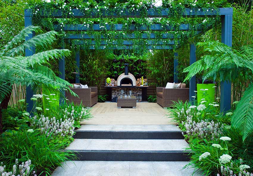 Modern pergola with outdoor fireplace and relaxing furniture