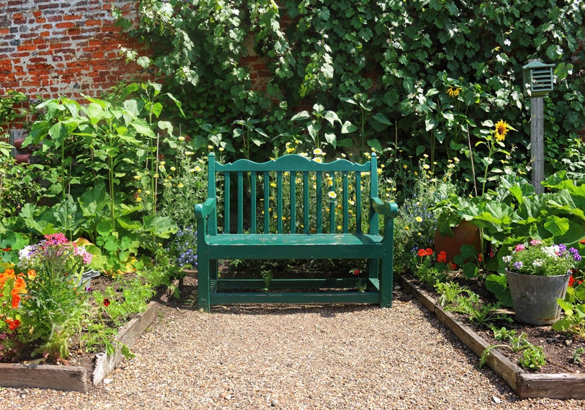 Painted green wood bench in garden