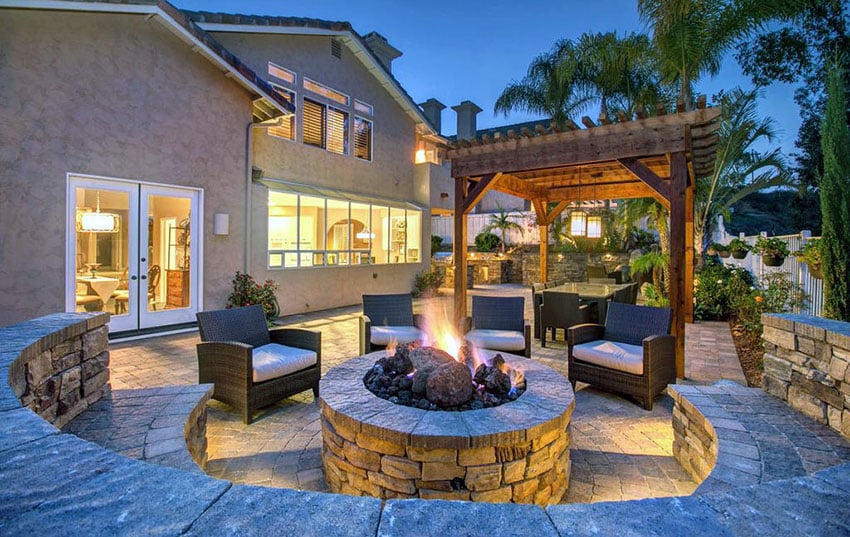 Patio with stone firepit and curved stone bench seating
