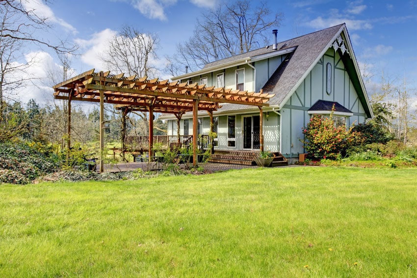 Pergola connected to a raised deck of a country house