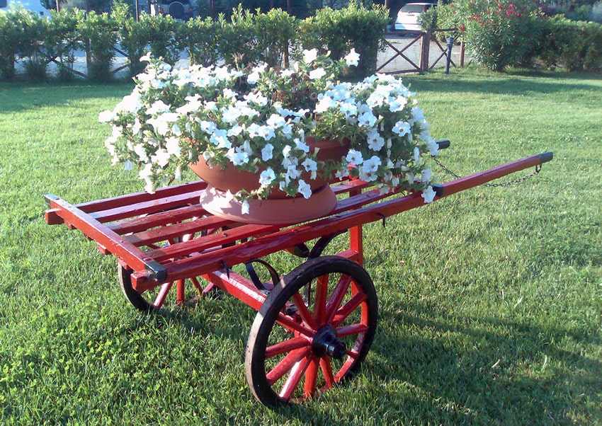 Red old fashioned flower cart