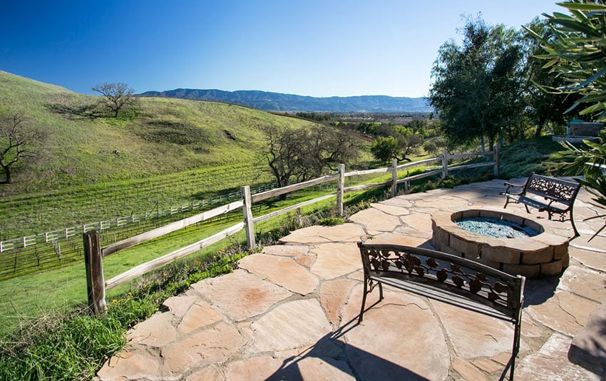 Rustic flagstone patio with two benches