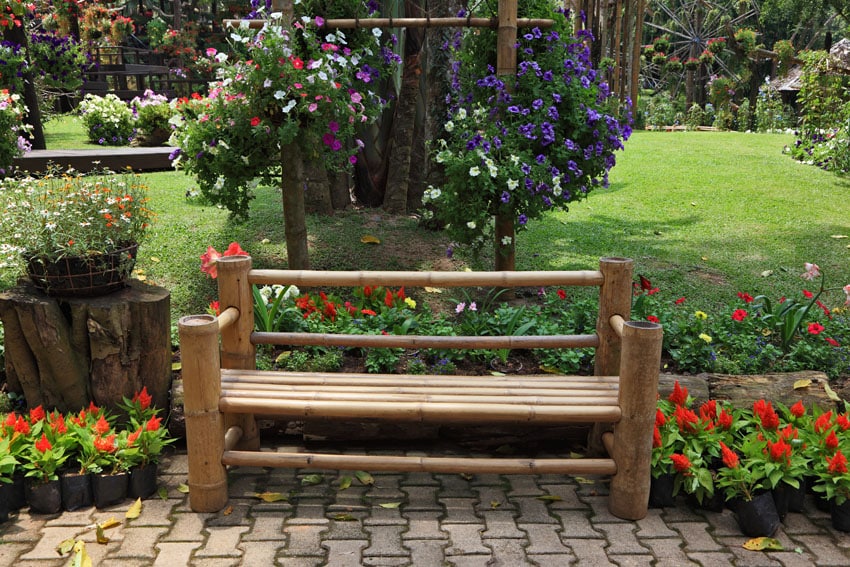 Rustic wood bench in flower garden