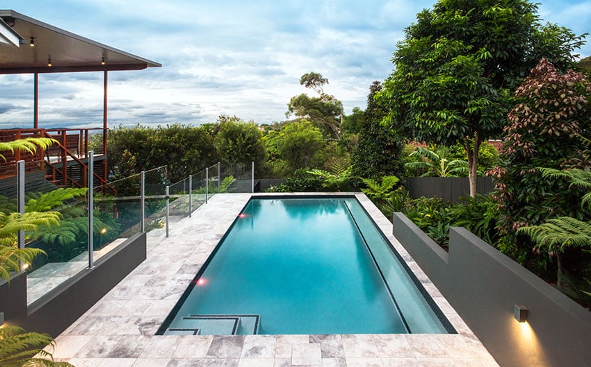 Elevated rooftop swimming pool with modern glass fence