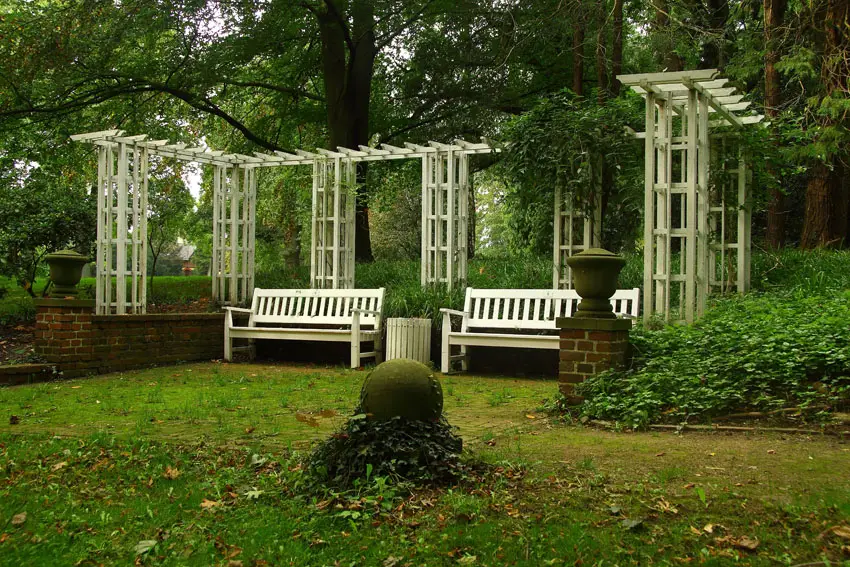White garden pergola with benches
